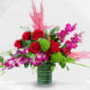 Red roses and pink orchids in a glass vase