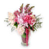 Pink and white floral arrangement in a clear glass vase