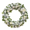 Round floral wreath with white roses and mixed white blooms