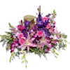 Pink and purple floral arrangement with a candle centerpiece