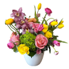 Mixed bouquet of pink, yellow, and purple flowers in a white vase