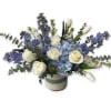 Blue and white floral arrangement in a ceramic vase