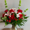 Designer's choice of star fighter lilies, roses, and spray roses. Perfect to