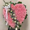 Heart-shaped pink floral standing spray with white roses and ribbon