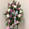 Standing floral spray with pink and white flowers on an easel
