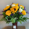 A bright and cheerful bouquet made with sunflowers, yellow roses, white roses