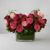 This romantic arrangement showcases a lush collection of premium red and pink