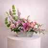 Pink lilies and roses in a gray rectangular planter