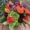 Bouquet of orange and red roses with tulips and purple flowers