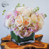 Cream and pink rose bouquet in a square glass vase