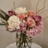Pink and white floral arrangement in a clear glass vase
