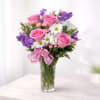 A joyful mix of classic red roses, crisp white daisies, soft pink