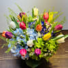Colorful bouquet of tulips and hydrangeas in a low container