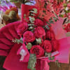 Bouquet of hot pink roses with eucalyptus in pink wrapping