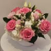 Pink roses and white hydrangeas arranged in a white bowl vase