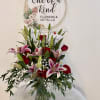 Bouquet of pink lilies and red roses in a glass vase
