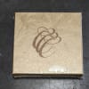 Gold decorative gift box with a brown abstract swirl design