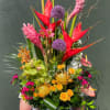 Towering red heliconia and sculptural pink ginger make a dramatic first impression