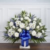 White daisies and roses in a blue ribboned vase arrangement