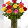 Colorful roses arranged in a clear glass vase