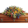 Colorful floral casket spray on a wooden coffin