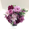 Purple and pink bouquet in a black vase