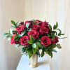 Bouquet of deep pink roses in a gold vase