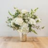 White rose and hydrangea arrangement in a gold vase