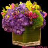 Purple hydrangeas and pink tulips in a square glass vase