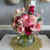 Pink and white rose bouquet in a clear glass vase