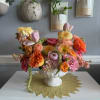 Colorful flower arrangement in a white pedestal bowl