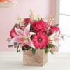 Pink and white flower arrangement in a wooden box