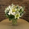 White floral arrangement in a clear glass vase