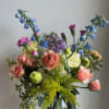 A beautiful vase arrangement filled with fresh seasonal flowers in the prettiest