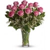 Pink roses arranged in a clear glass vase
