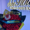 Bouquet of red roses with a small crown and graduation topper