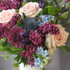 Sweet lilacs, pink roses and touch of blue, arranged perfectly in a