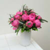 Pink peony bouquet in a white vase