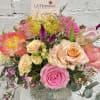 Pink and peach mixed bouquet in a speckled vase