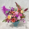 Colorful mixed flower arrangement in a blue vase