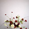 Deep crimson and burgundy blooms weave through soft ivory florals, creating a