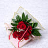 Bouquet of red roses with pink wrapping and a red ribbon