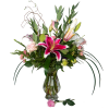 Tall arrangement of pink lilies and roses in a clear glass vase with a single pink rose at the base