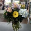 Clear glass vase bouquet with hydrangeas, roses, gerbera daisies and spray roses
