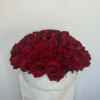 Round arrangement of red roses in a white hat box