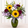 Bright yellow sunflowers take center stage in this Sun Kissed flower arrangement