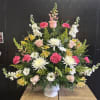 A dignified standing sympathy arrangement that comforts with soft color and classic