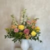 A STUNNING CERAMIC VASE ARRANGEMENT FEATURING PINK LISIANTHUS, SNAPDRAGON, ROSES, DIANTHUS AND
