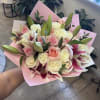 A lush wrap of one dozen pink roses, one dozen white roses