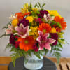 A tropical colored mixed arrangement perfect for cheerful occasions! 